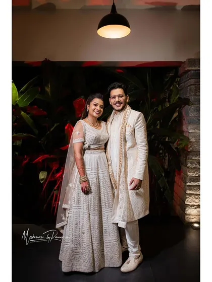 Another full-length portrait of the couple, showcasing their coordinated outfits.
