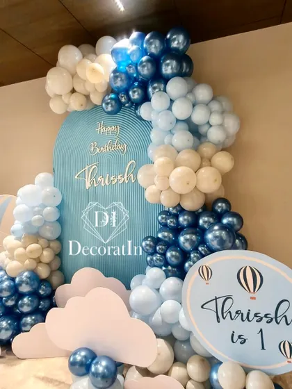 Another angle of the hot air balloon setup, showing the custom sign and the layered cloud cutouts at the base.
