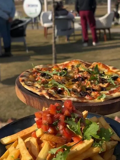 Pizza and loaded fries with a view of the driving range. It's the perfect casual meal to enjoy after a practice session.