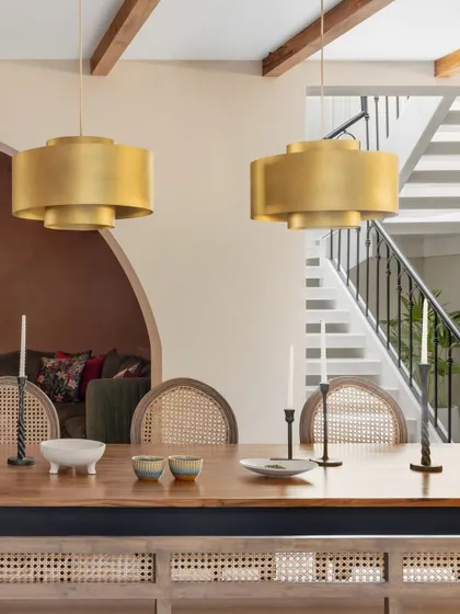 The finished dining area, looking towards the staircase. The transformation from a construction site to a warm, inviting home with layered lighting and textures is what our full-service design process is all about.