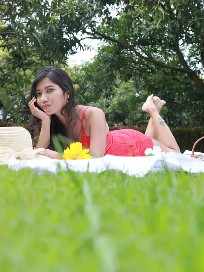 A playful and engaging portrait from the picnic shoot, with the model lying on her stomach.