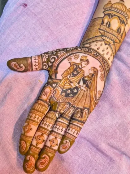 A close-up of a custom bride and groom portrait design. I focus on capturing the details of the couple's attire and expressions to make the mehndi truly unique.