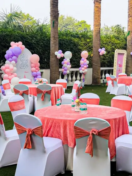Another view of the beautifully arranged guest tables at the outdoor princess party. The consistent color scheme creates an elegant and polished look.