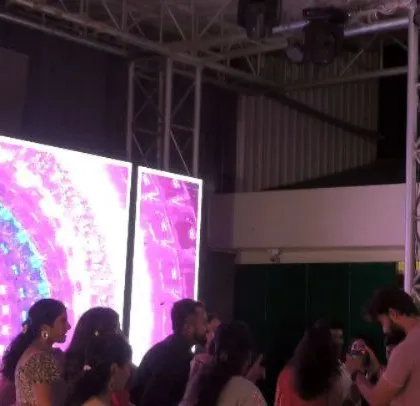 A South Indian wedding cocktail dinner with a large LED screen and truss setup.