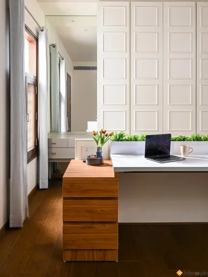 Another view of the home office, showing the natural light from the window and the clean, organized setup.