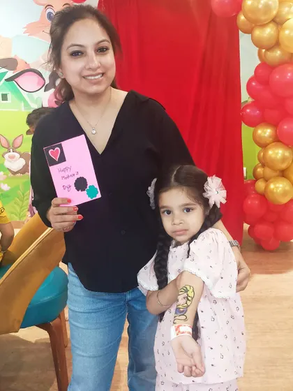I love creating special moments for families to share. A mother and daughter proudly show off her new face paint and the handmade card she created during our Mother's Day workshop.