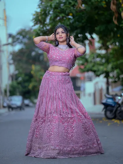 Perfect for a reception or sangeet, this modern pink lehenga is paired with a sparkling diamond-look choker set. Rent this complete look for a glamorous and contemporary style.