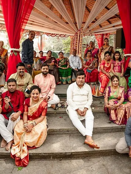 A candid shot of the entire family gathered for a group photo at the wedding venue.