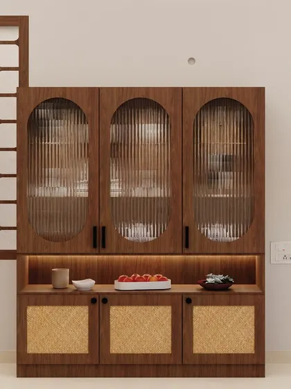 This stunning crockery unit features fluted glass doors and a rattan-infused base, creating an airy and elegant design. The warm under-lighting highlights the displayed items beautifully.