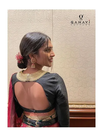 The back view of Bindu's ensemble, showcasing the stunning open-back design of the blouse with its embroidered collar detail. It's a perfect blend of traditional embroidery and modern tailoring.