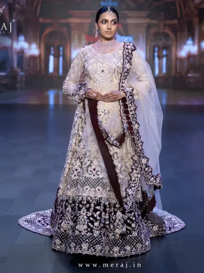 Step into the spotlight like royalty with this breathtaking Gold and Maroon Indo-Western ensemble, featuring a velvet tail lehenga and a net double-layer peplum top.