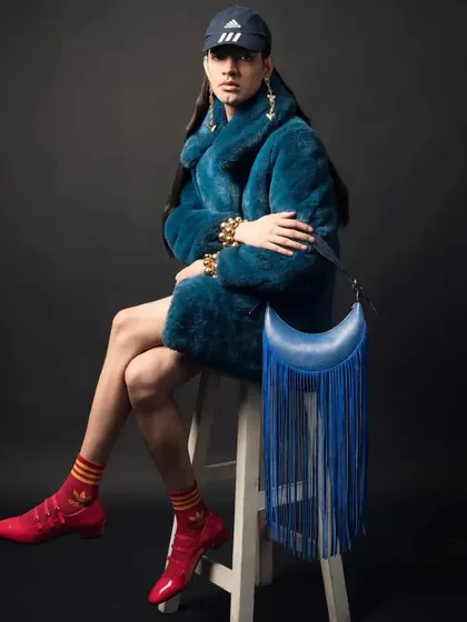 Spotted: a model rocking our Selena Fringe Blue Azure bag in a high-fashion photoshoot. The dramatic fringe and bold color make it a true statement piece.