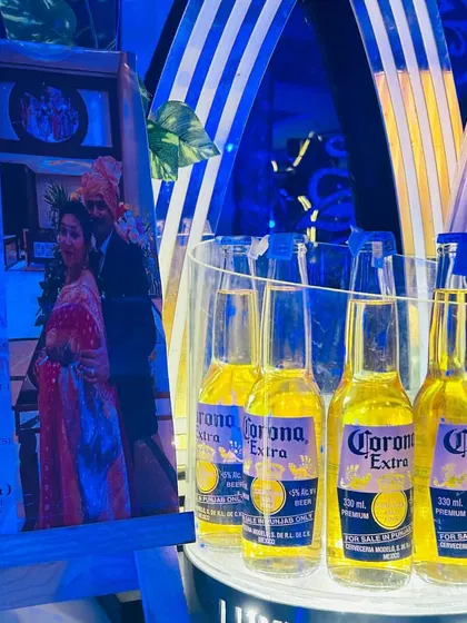 A personalized touch with a custom cocktail menu featuring a photo of the happy couple, alongside a display of Corona beers.