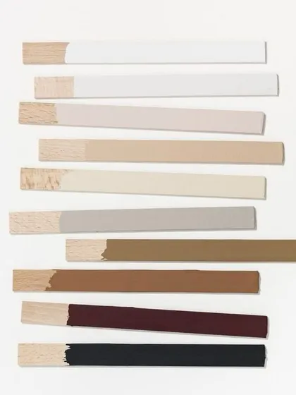 The details make the design. This image shows a selection of wood samples painted with different neutral and bold colors. This is a crucial step in my process to find the perfect hue for a project.