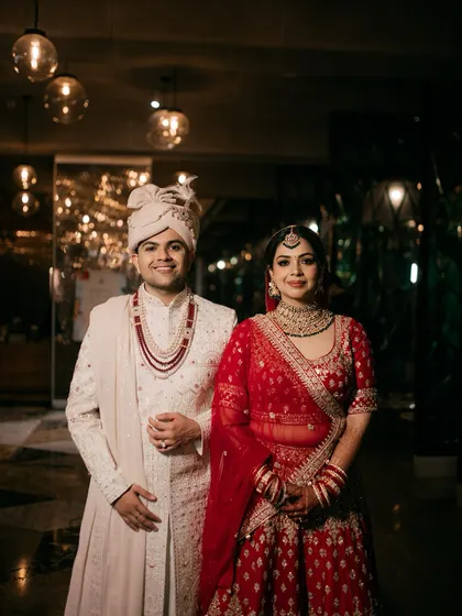 A moment of calm and elegance on their special day. This classic wedding portrait captures the couple in their beautiful traditional attire, a timeless memory of their wedding.