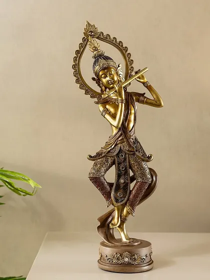 A graceful sculpture of Krishna playing the flute, finished in an antique bronze style. This piece captures the divine musician in a classic pose, perfect for adding a touch of spiritual art to a shelf or table.