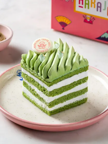 A matcha and white chocolate layered pastry, showcasing its clean lines and vibrant green color for a Japanese-inspired dessert menu.