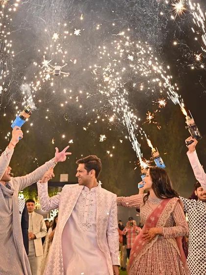 Love, laughter, and a grand celebration with cold pyros. This shot captures the energy of a Sangeet finale, a moment of pure joy for the couple and their guests.
