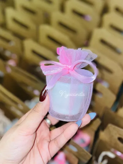 These mini scented candles in a jar, wrapped in pink net, are a simple and affordable favor perfect for any wedding event.