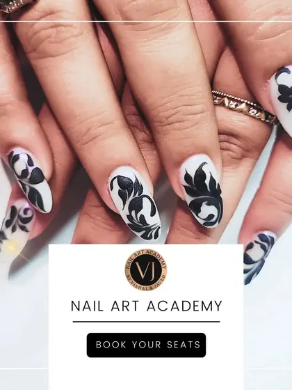 This image showcases our intricate black and white floral nail art on long, almond-shaped nails. The detailed, hand-painted patterns create a sophisticated and timeless look that is perfect for any occasion.