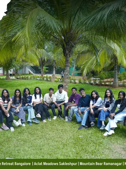 A happy group of friends posing for a picture under the palm trees. Our resorts are designed to be the perfect backdrop for creating memories with your crew.