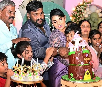 A happy cake-cutting moment surrounded by family and friends at the enchanted garden party.
