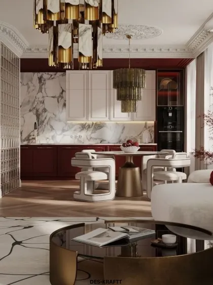 A bold and dramatic take on open-plan living, this design features rich burgundy cabinetry in the kitchen area, contrasted with a white sofa and striking tiered chandeliers.