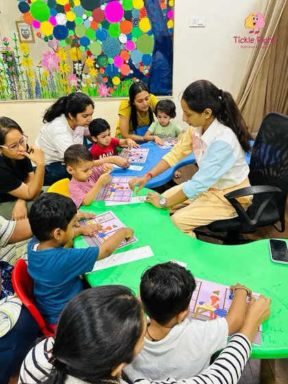 A full classroom with children and parents gathered around the trainer shows the vibrant community we build. Learning is a shared adventure at Tickle Right.