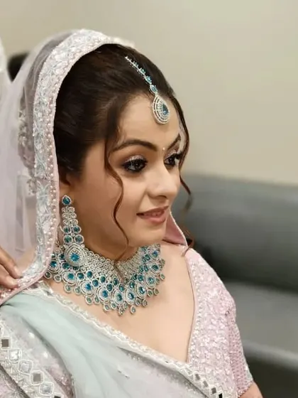 A side view of the messy bun, showing the soft tendrils that frame the face. This adds a touch of romance to the overall bridal look.