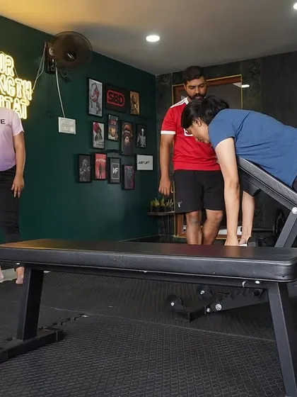 Here I am coaching a client on proper form for an incline row. At BASE, we focus on teaching the 'why' behind every movement in a supportive group setting.