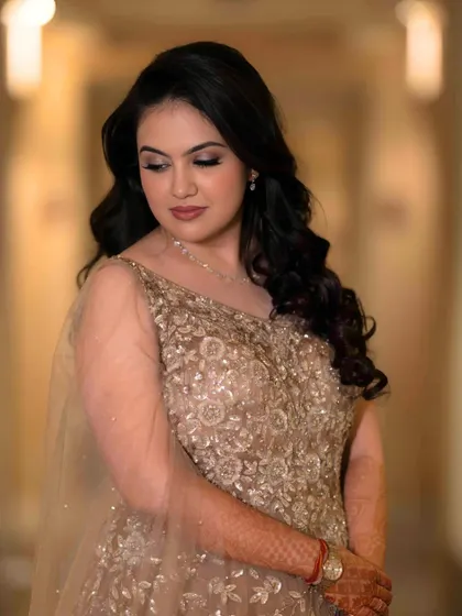 A beautiful portrait of the bride-to-be. Her soft, romantic makeup and gentle waves create an effortless yet glamorous look for her engagement.