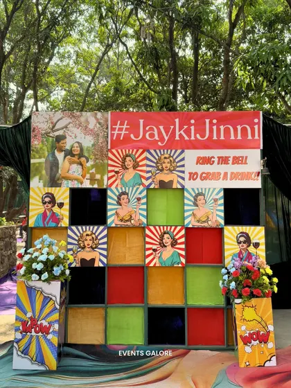 An interactive 'grab a drink' wall was a fun and engaging element at the Haldi. The retro pop-art design and the custom hashtag made it a popular spot for photos.
