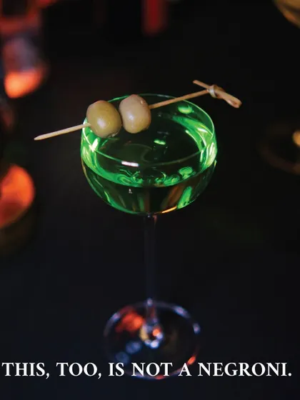 A striking, bright green cocktail with the text "This, too, is not a negroni." This visual was part of our campaign to introduce our colorful and innovative Negroni Week offerings.