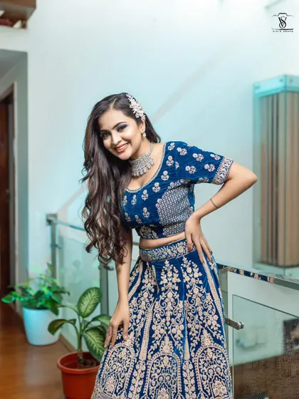 A happy and radiant shot in the peacock blue lehenga. The outfit is paired with a beautiful silver choker, which is also available for rent.