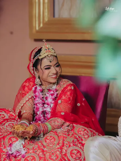 A candid shot of the bride smiling during a wedding ritual. Her natural happiness shines through, making for a beautiful and authentic memory.