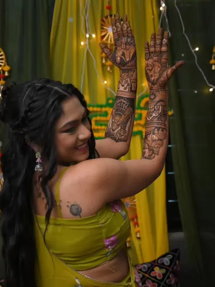 A happy bride dancing and showing off her bridal mehandi. We love to see our brides enjoying their special day to the fullest.