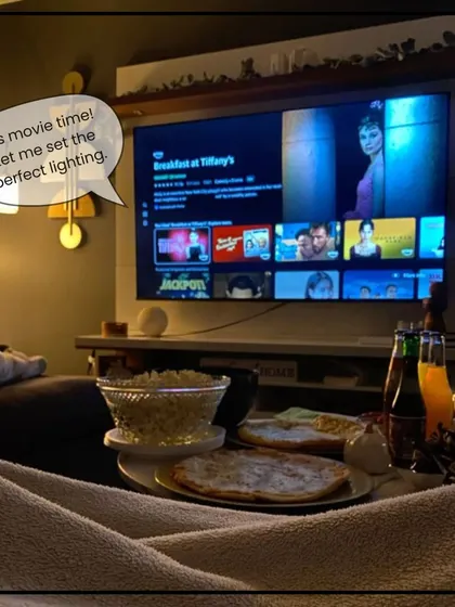 It's movie time! Our system knows what that means. We can program a scene that automatically dims the lights to create the perfect cinematic experience at home.