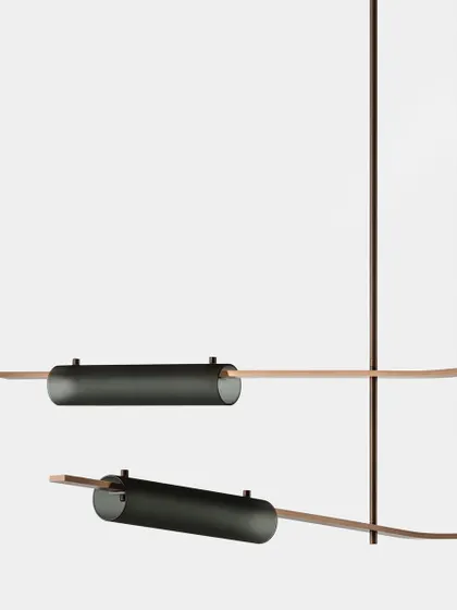 A detailed view of the Volant system with blackened brass and smoked glass finishes, showcasing the sophisticated material options.