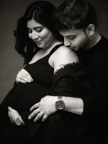 This close-up black and white shot focuses on the gentle touch and loving expressions, creating a powerful and emotional image.