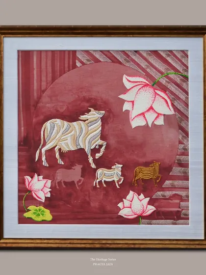 "The Nandi Collection," a piece from my Heritage Series, embroidered on linen. The rich red background and intricately stitched lotuses create a vibrant setting for the sacred cows.