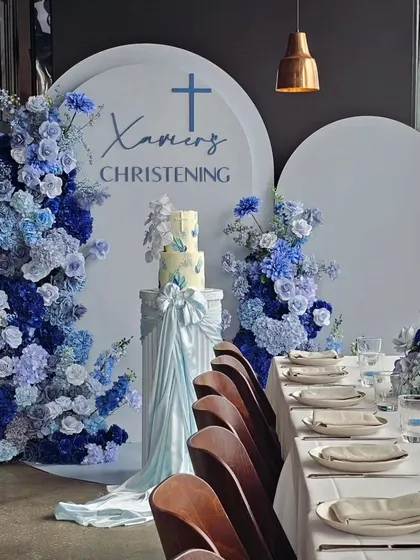 A breathtaking baptism decor in shades of blue. The cascading floral arrangements and elegant tablescape create a serene and visually stunning environment for a sacred celebration.