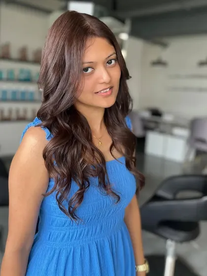 A portrait of the happy client, her new hair color perfectly complementing her skin tone.