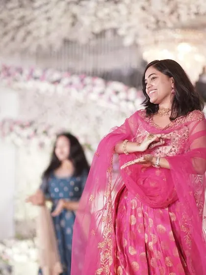 The bride and her friends perform a graceful dance at the reception, a beautiful tribute to the celebration of love.