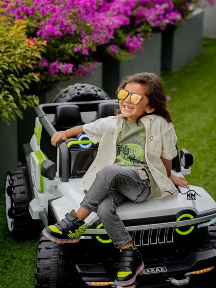 This cool dude is ready to hit the road. Using fun props like a ride-on jeep adds a playful and modern touch to an outdoor toddler session.