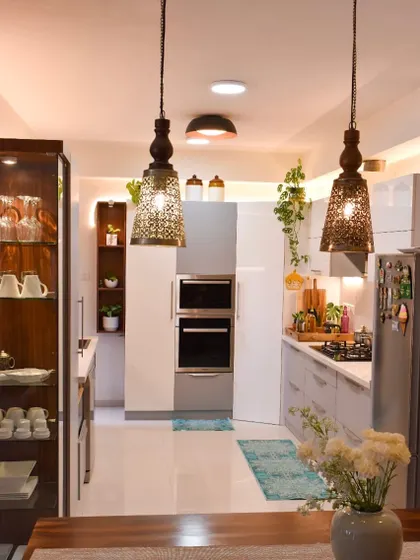 A view from the dining area into the kitchen. The pendant lights add a touch of traditional charm to the otherwise modern space.
