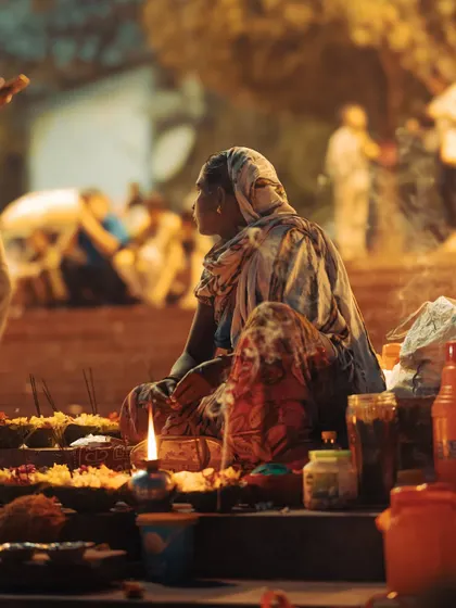 A woman selling offerings for the Ganga Aarti in Rishikesh. This photo captures the human element and the preparations behind the grand spiritual ceremonies.