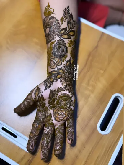 This single-hand design is packed with detail, from shaded roses to delicate leaves and spirals. It demonstrates how even a smaller piece can have a big impact.