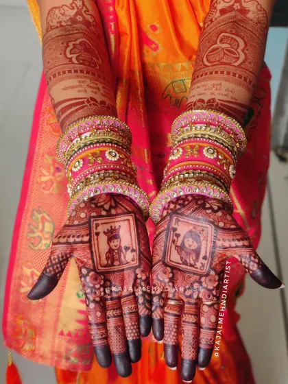 The King and Queen of hearts, right on your palms. This creative design uses playing card motifs to represent the bride and groom, shown here with a beautiful, deep henna stain.