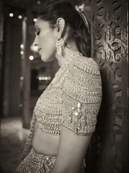 An artistic, monochrome shot that highlights the texture and detail of the blouse.