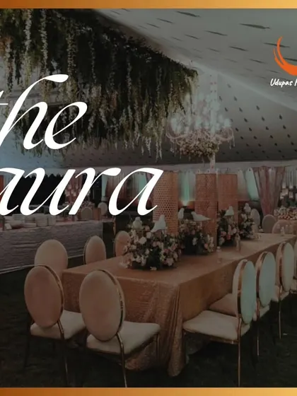 The aura of our celebrations is defined by elegance and style. This image shows a beautifully set long dining table with hanging floral decor, perfect for an intimate and luxurious wedding reception.